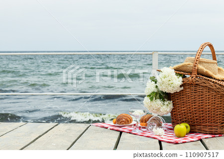 The concept of a picnic by the sea, with flowers. 110907517
