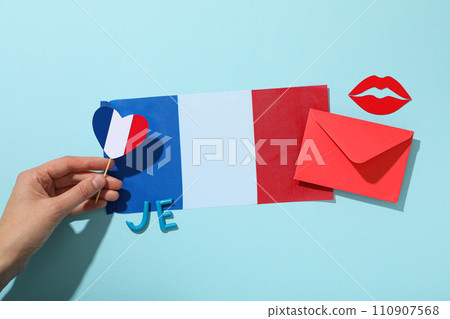 Flag of France and other symbols on a blue background. 110907568