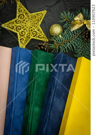 Cristmas gift. Notebook as a Christmas present. Close up of a blank velour fluffy notebook on black background with clipping path 110907623