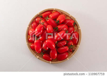 Ripe cherry tomatoes Aiko colander overhead view 110907759