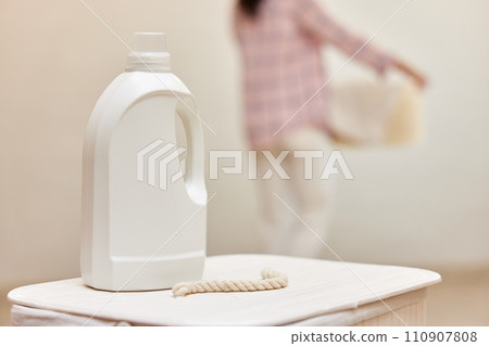 washing gel or laundry detergent on white laundry basket. Mock up, copy space. washing gel or laundry detergent on white laundry basket. Mock up, copy space. 110907808