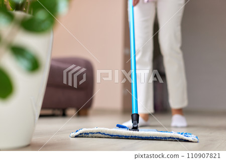 young woman cleaning and mopping floor at living room, daily housekeeping , close-up young woman cleaning and mopping floor at living room, daily housekeeping , close-up 110907821