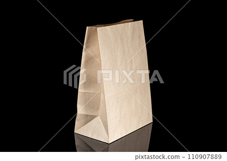 Recyclable craft paper bag for purchases, gifts and takeaway food mock up on black background. Environmentally friendly than single-use plastic bags 110907889