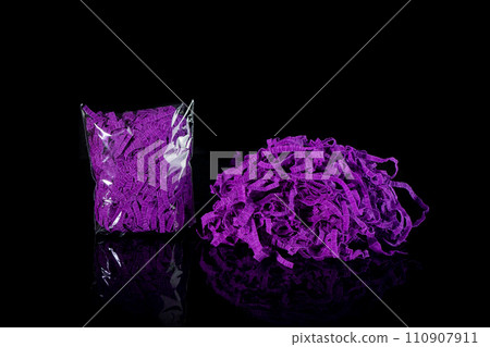 Closeup decorative Shredded color craft tissue paper black background Closeup decorative Shredded color craft tissue paper black background 110907911