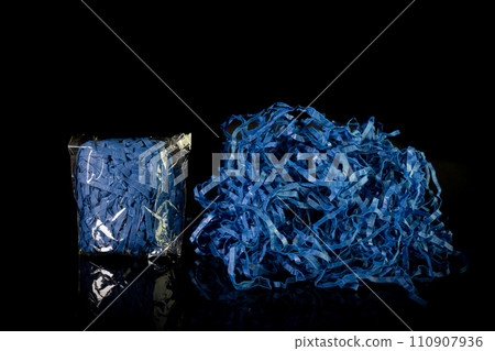 Closeup decorative Shredded color craft tissue paper black background Closeup decorative Shredded color craft tissue paper black background 110907936