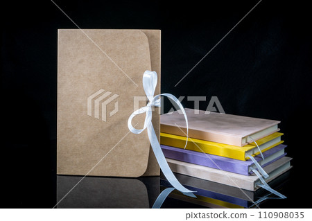 Best gift for men. Man gift concept. Various notebooks with craft gift box black background. Copy space text. Valentine's day, wedding, birthday and special occasion gift concept. Copy space for text. Best gift for men. Man gift concept. Various notebooks with craft gift box black background. Copy space text. Valentine's day, wedding, birthday and special occasion gift concept. Copy space for text. 110908035