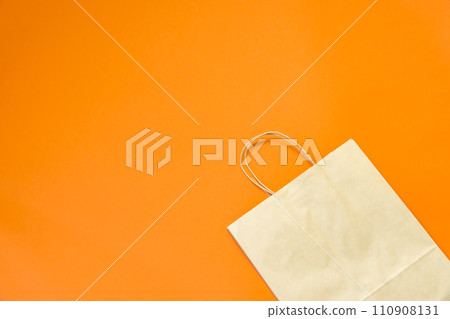 Top view brown paper shopping bag on colourful background, Mock-up of blank brown paper shopping bag and copy space. Flat lay. 110908131