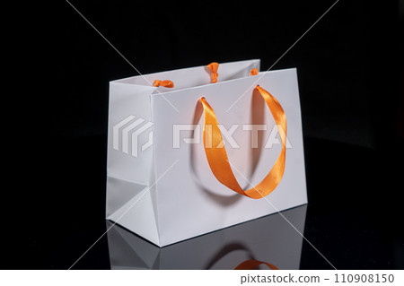 Recyclable craft paper bag for purchases, gifts and takeaway food mock up on black background. Environmentally friendly than single-use plastic bags 110908150