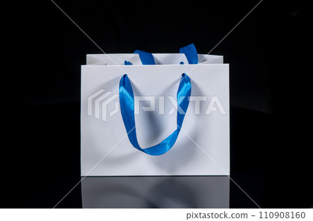 Recyclable craft paper bag for purchases, gifts and takeaway food mock up on black background. Environmentally friendly than single-use plastic bags 110908160