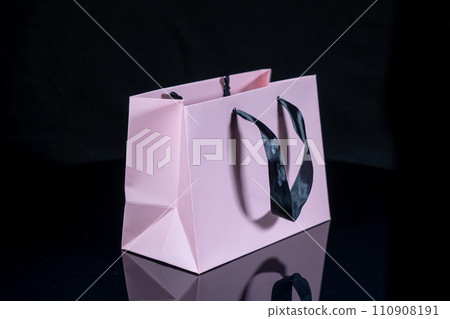 Recyclable craft paper bag for purchases, gifts and takeaway food mock up on black background. Environmentally friendly than single-use plastic bags 110908191