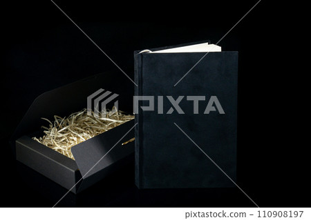 Best gift for men. Man gift concept. Black notebook with black gift box on black background. Copy space text. Valentine's day, wedding, birthday and special occasion gift concept. Copy space for text. Best gift for men. Man gift concept. Black notebook with black gift box on black background. Copy space text. Valentine's day, wedding, birthday and special occasion gift concept. Copy space for text. 110908197