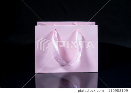 Recyclable craft paper bag for purchases, gifts and takeaway food mock up on black background. Environmentally friendly than single-use plastic bags Recyclable craft paper bag for purchases, gifts and takeaway food mock up on black background. Environmentally friendly than single-use plastic bags 110908199
