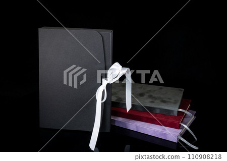 Best gift for men. Man gift concept. Various notebooks with craft gift box black background. Copy space text. Valentine's day, wedding, birthday and special occasion gift concept. Copy space for text. 110908218