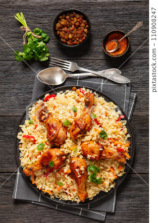 fried chicken drumsticks over rice pilaf, top view 110908247