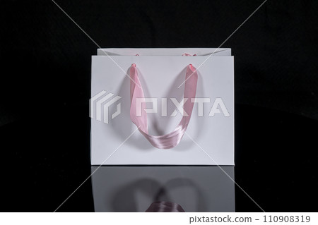 Recyclable craft paper bag for purchases, gifts and takeaway food mock up on black background. Environmentally friendly than single-use plastic bags 110908319