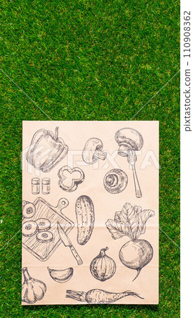 a paper bag lies on the green grass, moss, mock up 110908362