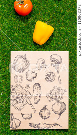 a paper bag lies on the green grass with fruits and vegetables around, moss, mock up 110908378