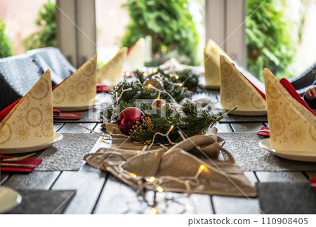 Festive dinner table setting decoration for christmas with Paper, lights Festive dinner table setting decoration for christmas with Paper, lights 110908405