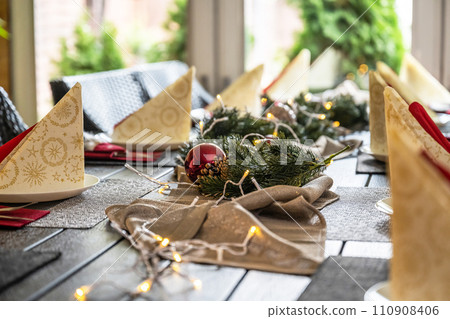Festive dinner table setting decoration for christmas with Paper, lights Festive dinner table setting decoration for christmas with Paper, lights 110908406