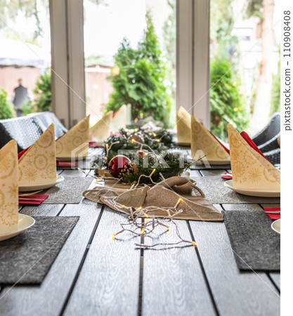 Festive dinner table setting decoration for christmas with Paper, lights 110908408