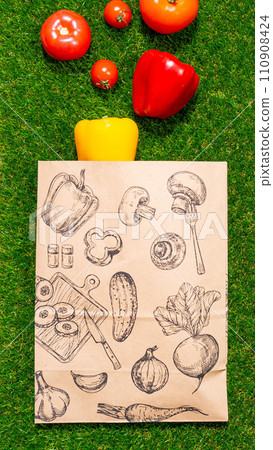 a paper bag lies on the green grass with fruits and vegetables around, moss, mock up a paper bag lies on the green grass with fruits and vegetables around, moss, mock up 110908424