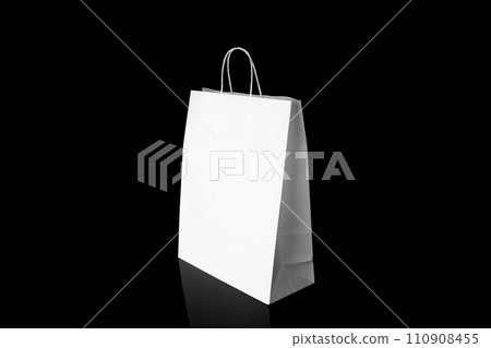 Recyclable craft paper bag for purchases, gifts and takeaway food mock up on black background. Environmentally friendly than single-use plastic bags Recyclable craft paper bag for purchases, gifts and takeaway food mock up on black background. Environmentally friendly than single-use plastic bags 110908455
