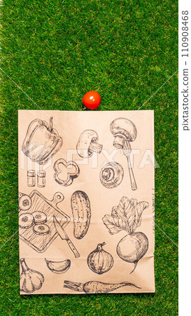 a paper bag lies on the green grass with fruits and vegetables around, moss, mock up 110908468