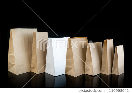 Set of paper bags for shopping on black background. Mockup for design 110908641