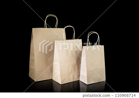 Set of paper bags for shopping on black background. Mockup for design 110908714