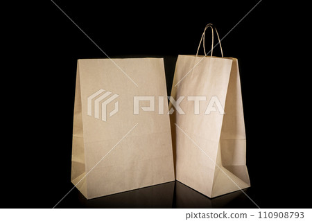 Set of paper bags for shopping on black background. Mockup for design 110908793