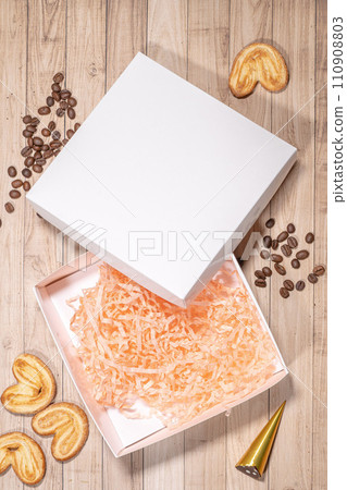 White box mockup between different sweets on the table and figures 110908803