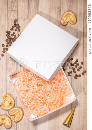 White box mockup between different sweets on the table and figures White box mockup between different sweets on the table and figures 110908806