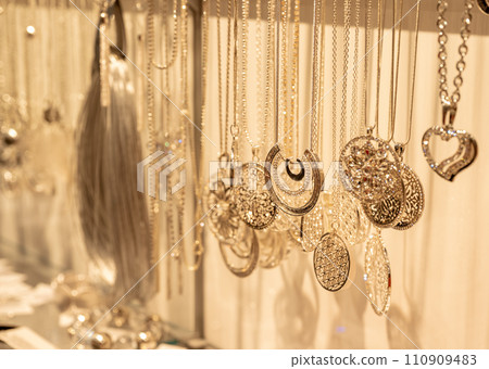 blurred gold jewelry necklace chains for background, panel gold shop jewelry store for seller products and gold showcase 110909483