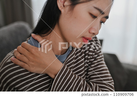 Upset young woman touching neck, suffering from pain and strain. Healthcare and problem concept Upset young woman touching neck, suffering from pain and strain. Healthcare and problem concept 110909706