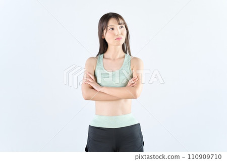 A woman wearing sportswear thinking A woman wearing sportswear thinking 110909710