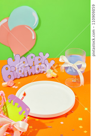 A white ceramic plate is displayed on an orange background. Cute shapes are cut from colored paper and decorated with confetti. Free space for display. A white ceramic plate is displayed on an orange background. Cute shapes are cut from colored paper and decorated with confetti. Free space for display. 110909859