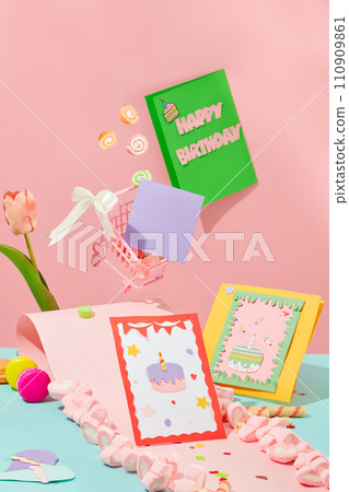 Greeting cards with cute designs. Macaron and marshmallow decorated on the background. Copy space with front view. Backdrop with two main colors: pink and blue. Greeting cards with cute designs. Macaron and marshmallow decorated on the background. Copy space with front view. Backdrop with two main colors: pink and blue. 110909861