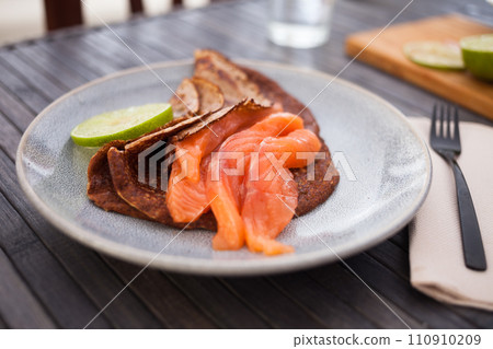Salted salmon fillet with buckwheat pancakes and lime 110910209