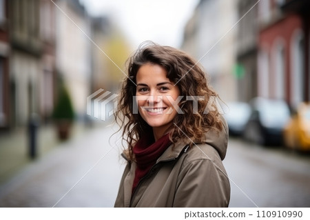 Portrait of a beautiful young woman smiling in a city street Portrait of a beautiful young woman smiling in a city street 110910990