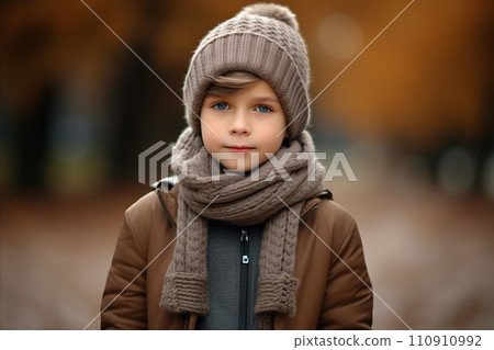 Portrait of a cute little girl in a warm hat and scarf. Portrait of a cute little girl in a warm hat and scarf. 110910992