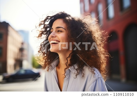 Closeup portrait of a beautiful young woman with curly hair smiling outdoors. Closeup portrait of a beautiful young woman with curly hair smiling outdoors. 110911010