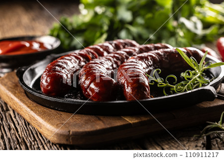 Sausages fried with spices bbq sauce and herbs - Close up 110911217