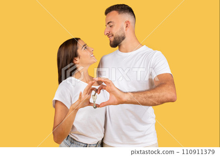 Positive romantic millennial european family in white t-shirts hugs, making heart gesture with hands Positive romantic millennial european family in white t-shirts hugs, making heart gesture with hands 110911379