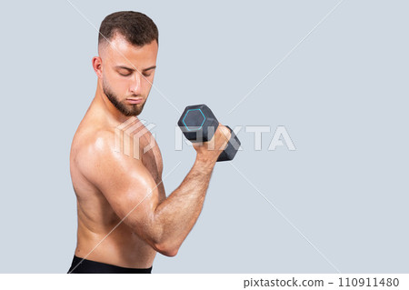 Serious sweat strong muscular millennial european man athlete with beard, naked torso make exercises with dumbbell 110911480
