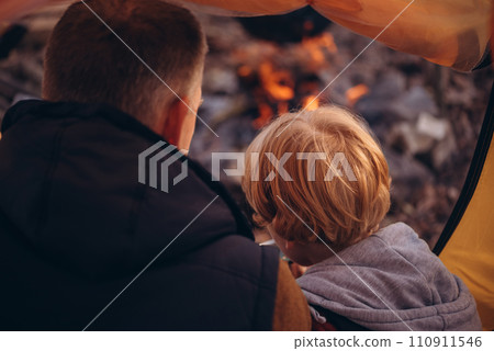 Man and boy tourists autumn time leisure, vacation hiking or traveling touristic activity. Family camping, father and little son relax in forest camp. 110911546