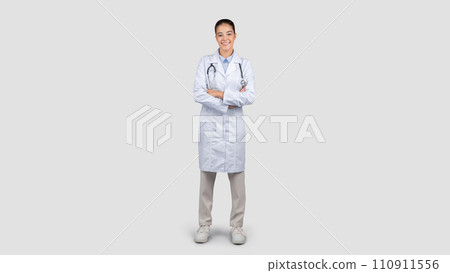 Positive millennial european woman doctor with arms crossed, in white coat 110911556