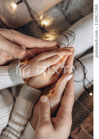 A family is unraveling a New Year's Christmas garland. 110911568