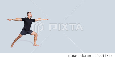 Focused calm handsome strong millennial european man with beard in sportswear practice yoga 110911628