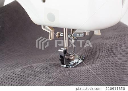 Sewing machine, stitching fabrics, needle in a round plan Sewing machine, stitching fabrics, needle in a round plan 110911850