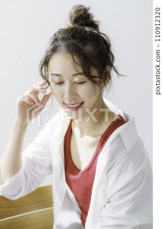 Portrait of a young woman with bun hair, vertical position Portrait of a young woman with bun hair, vertical position 110912320